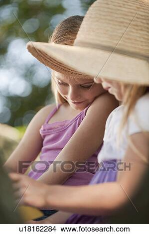 Picture - Girls reading outside. Fotosearch