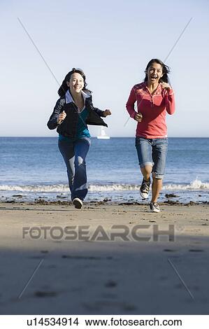 Girls running on beach View Large Photo Image Picture - Girls running on beach. Fotosearch