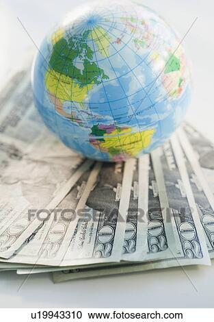 Globe on top of money View Large Photo Image Stock Image - Globe on top of money. Fotosearch