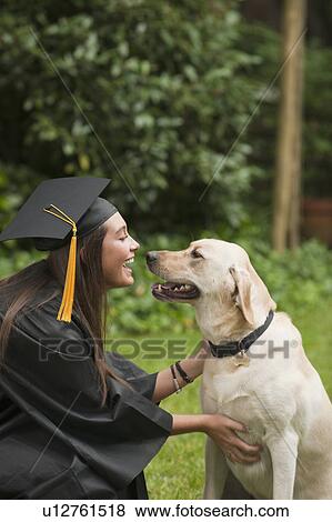 Stock Photo - Graduate and dog. Fotosearch