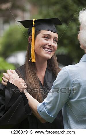 Stock Image - Graduate and elderly woman. Fotosearch