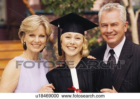 Stock Image - Graduate with parents. Fotosearch