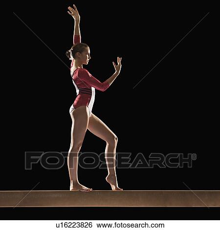 Gymnast on balance beam View Large Photo Image Stock Photograph - Gymnast on balance beam. Fotosearch
