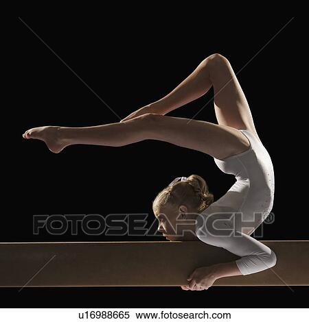 Stock Photography - Gymnast on balance beam. Fotosearch