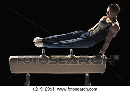 Stock Image - Gymnast on pommel horse. Fotosearch