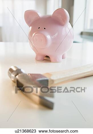 Stock Image - Hammer and piggy bank. Fotosearch