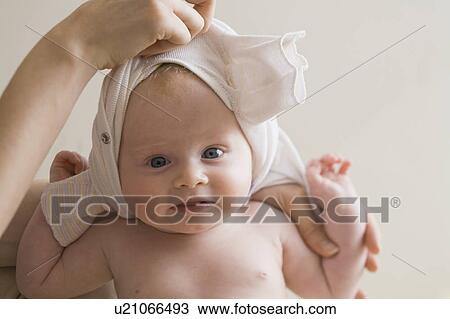 Hand changing baby's clothes View Large Photo Image Stock Image - Hand changing baby's clothes. Fotosearch