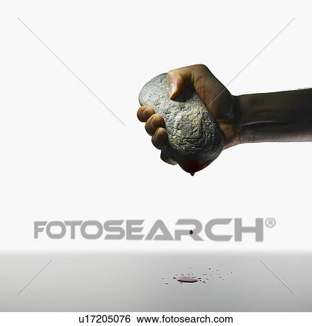 Hand holding a stone View Large Photo Image Stock Photograph - Hand holding a stone. Fotosearch