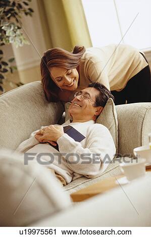 Happy couple in living room View Large Photo Image Stock Image - Happy couple in living room. Fotosearch