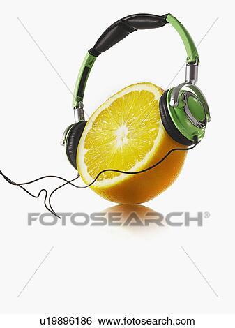 Stock Photograph - Headphones on lemon. Fotosearch