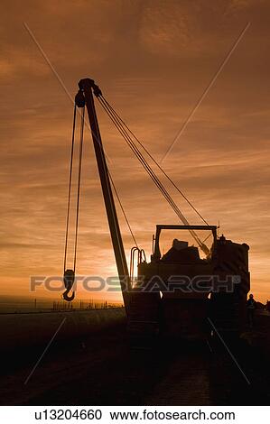 Heavy equipment at sunset View Large Photo Image Stock Image - Heavy equipment at sunset. Fotosearch