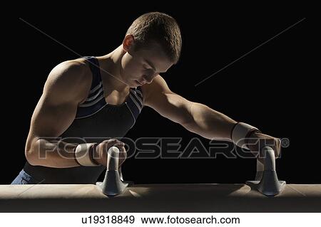 Stock Photo - Male gymnast stretching. Fotosearch