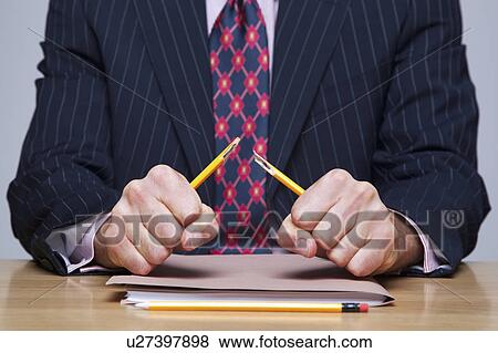 Man breaking pencil View Large Photo Image Stock Photo - Man breaking pencil. Fotosearch