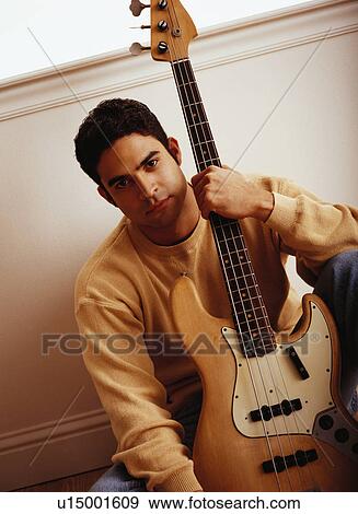Man holding electric bass View Large Photo Image Stock Photo - Man holding electric bass. Fotosearch