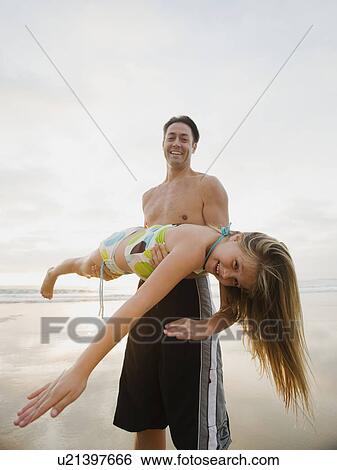 Man holding girl View Large Photo Image Stock Photograph - Man holding girl. Fotosearch