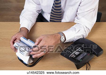 Stock Photography - Man looking up phone number. Fotosearch