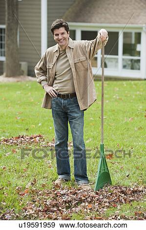 Stock Photo - Man raking leaves. Fotosearch