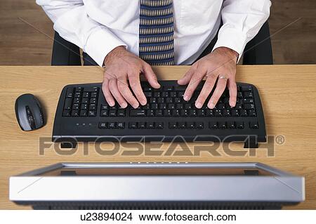 Picture - Man typing. Fotosearch