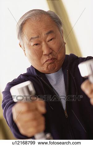 Man using dumbbells View Large Photo Image Stock Photo - Man using dumbbells. Fotosearch