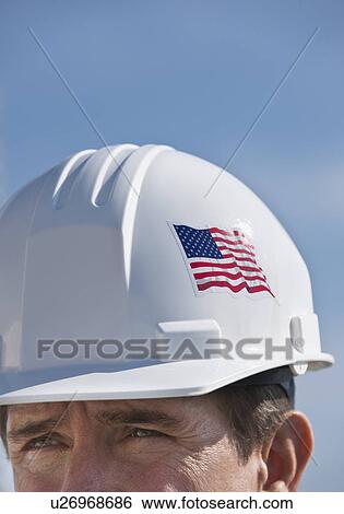 Stock Photograph - Man wearing hardhat. Fotosearch