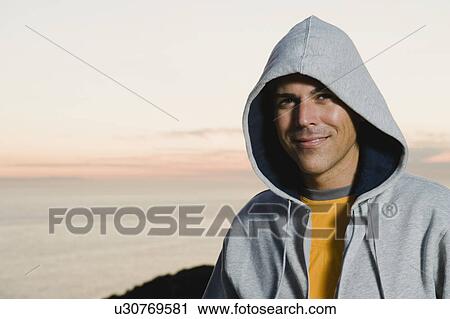 Stock Image - Man wearing hoodie. Fotosearch