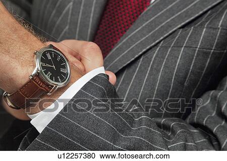 Man wearing wristwatch View Large Photo Image Stock Image - Man wearing wristwatch. Fotosearch