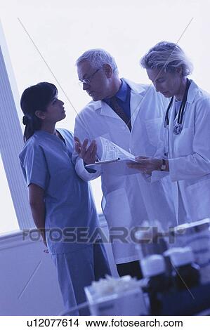 Medical team looking at chart View Large Photo Image Picture - Medical team looking at chart. Fotosearch
