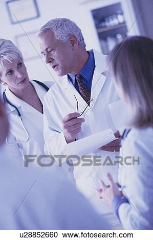Medical team looking at chart View Large Photo Image Stock Image - Medical team looking at chart. Fotosearch