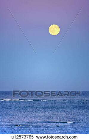 Stock Photography - Moonrise over ocean. Fotosearch