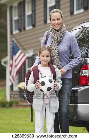 Stock Photo - Mother and daughter holding soccer ball. Fotosearch