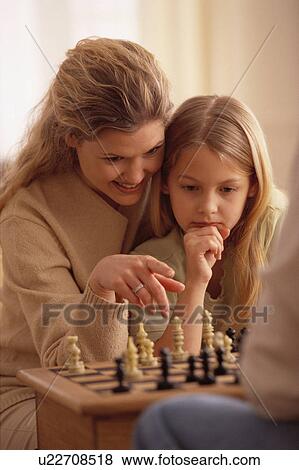 Mother and daughter playing chess View Large Photo Image Stock Photo - Mother and daughter playing chess. Fotosearch