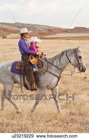 Mother and daughter riding horse View Large Photo Image Stock Photo - Mother and daughter riding horse. Fotosearch
