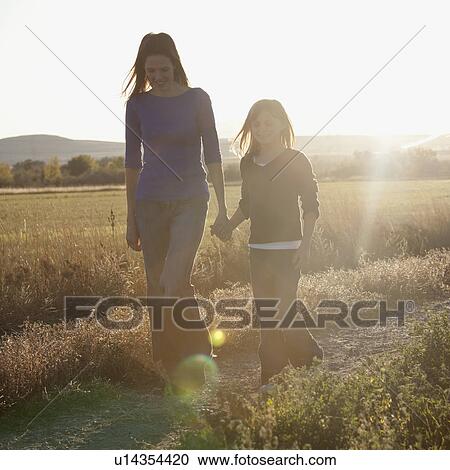 Mother and daughter walking View Large Photo Image Stock Image - Mother and daughter walking. Fotosearch