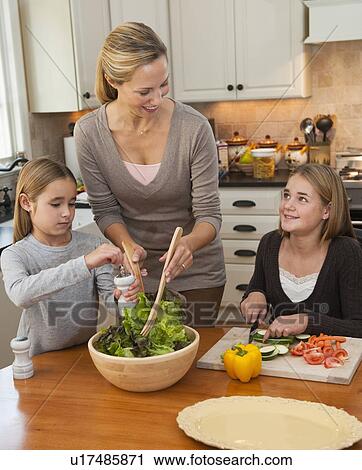 Mother and daughters making salad View Large Photo Image Stock Image - Mother and daughters making salad. Fotosearch