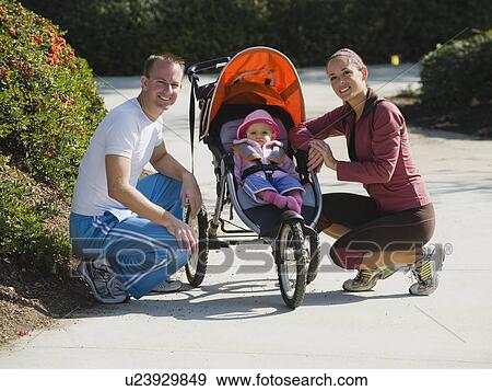 Stock Photo - Parents and stroller. Fotosearch