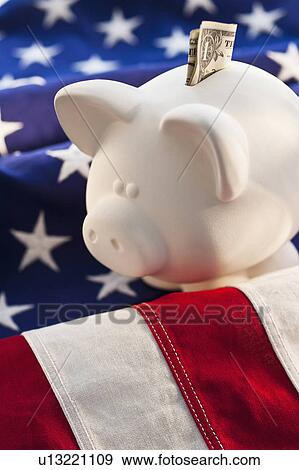 Piggybank on top of American flag View Large Photo Image Stock Photo - Piggybank on top of American flag. Fotosearch