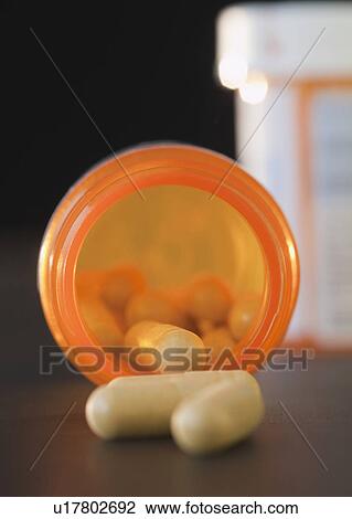 Stock Image - Pills spilled from container. Fotosearch
