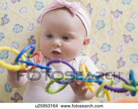 Portrait of baby girl playing with toy View Large Photo Image Picture - Portrait of baby girl playing with toy. Fotosearch