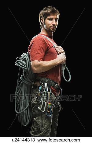 Portrait of male climber holding rope View Large Photo Image Stock Image - Portrait of male climber holding rope. Fotosearch