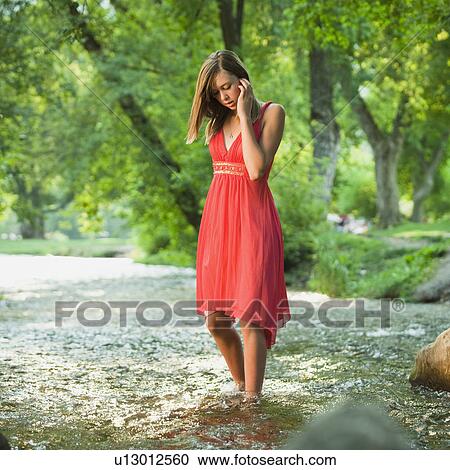 Portrait of woman standing in river View Large Photo Image Stock Image - Portrait of woman standing in river. Fotosearch