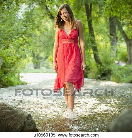 Portrait of woman walking in river View Large Photo Image Stock Photography - Portrait of woman walking in river. Fotosearch