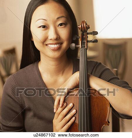 Stock Image - Portrait of woman with a violin. Fotosearch