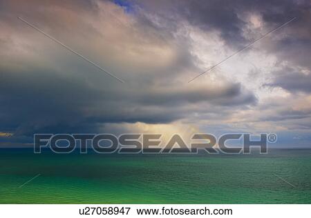 Stock Photo - Rainbow over ocean. Fotosearch