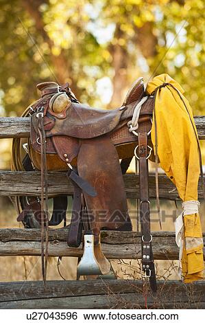 Stock Photograph - Saddle on fence. Fotosearch