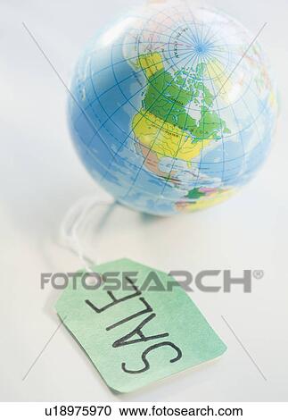 Stock Image - Sale tag beside globe. Fotosearch