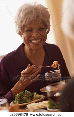Senior woman eating meal View Large Photo Image Stock Photograph - Senior woman eating meal. Fotosearch