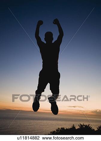 Stock Image - Silhouette of man jumping. Fotosearch