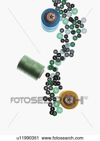 Stock Image - Spools of thread and buttons. Fotosearch