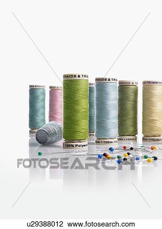 Stock Image - Spools of thread and pushpins. Fotosearch