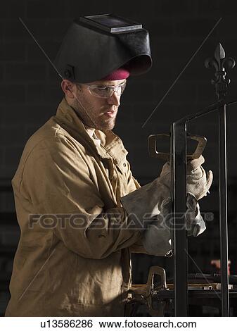 Stock Photograph - Steel grinder working in metal shop. Fotosearch
